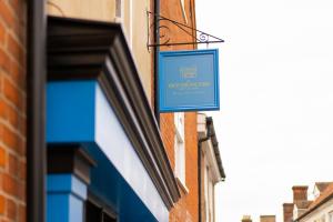 a blue sign hanging on the side of a building at The Ironmongers Boutique accommodation in Aylsham