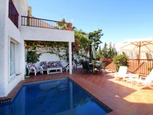 a swimming pool in a patio with a table and chairs at Holiday Home Mar y Montaña by Interhome in Benidorm