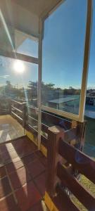 a building with a view of the ocean from a bench at Ilha Comprida - Morada do Sol in Ilha Comprida