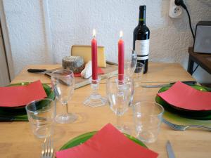 a table with wine glasses and red napkins and candles at Apartment Le Curling B - Val Claret-30 by Interhome in Tignes