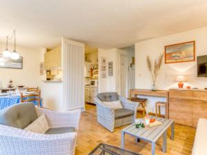 a living room with chairs and a table at Apartment Les Galiotes-1 by Interhome in Carnac-Plage