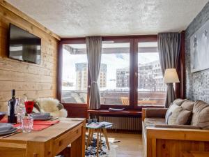 a living room with a couch and a table at Apartment Le Prariond - Val Claret-7 by Interhome in Tignes +22 photos
