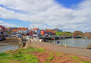 a town next to a body of water with houses at SeaView Loft in Dunbar