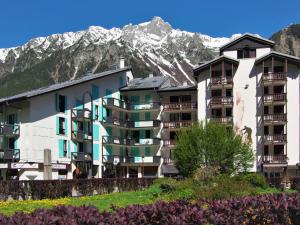 a large apartment building with mountains in the background at Studio La Forclaz-6 by Interhome in Chamonix