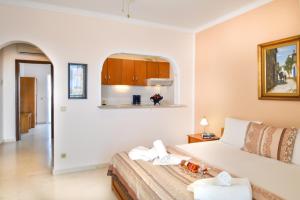 a bedroom with a large white bed in a room at Haus Despina in Sarti