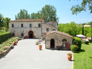 a large stone building with a driveway at Apartment Forno by Interhome in Rapolano Terme