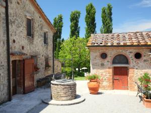 a stone building with a fountain in front of it at Apartment Rapolano-5 by Interhome in Rapolano Terme