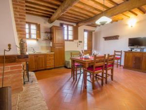 a kitchen with a table and chairs in a room at Apartment Rapolano-5 by Interhome in Rapolano Terme +34 photos