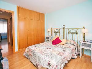 1 dormitorio con 1 cama y armario de madera en Apartment Mariola by Interhome, en Sant Andreu de Llavaneres