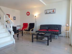a living room with a couch and chairs and a table at Apartment Les Marinas-7 by Interhome in Deauville