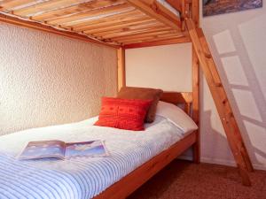 a bedroom with a bunk bed with a book on it at Studio Les Tommeuses - Val Claret-27 by Interhome in Tignes