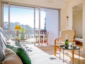 a living room with a couch and a glass table at Apartment Plein Ciel-1 by Interhome in Carnac-Plage +17 photos