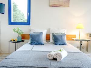 a bedroom with two beds with blue pillows at Apartment Plein Ciel-1 by Interhome in Carnac-Plage