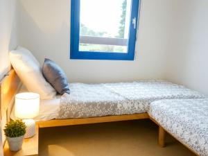 a bedroom with a bed with a blue mirror at Apartment Plein Ciel-1 by Interhome in Carnac-Plage