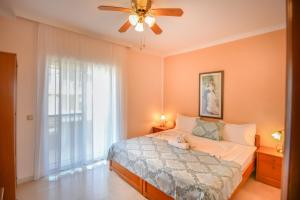 a bedroom with a bed and a ceiling fan at Haus Despina in Sarti