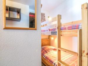 a bedroom with two bunk beds and a mirror at Studio Plein Soleil - Val Claret-9 by Interhome in Tignes