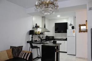 a kitchen with a chandelier and a counter top at Luxury apartament in Cádiz