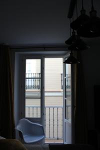 a sliding glass door with a view of a balcony at Luxury apartament in Cádiz