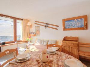 a living room with a table and a couch at Apartment Grandes Platières II-2 by Interhome in Tignes