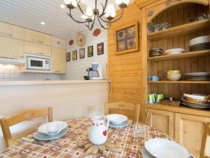 a kitchen with a table with a vase on it at Apartment Grandes Platières II-2 by Interhome in Tignes +12 photos