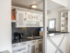 a kitchen with white cabinets and a sink at Apartment Les Embruns-2 by Interhome in Carnac