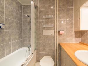 a bathroom with a tub and a toilet and a sink at Apartment Grandes Platières II-2 by Interhome in Tignes
