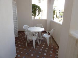 ベナルマデナにあるApartment Pueblo Quinta II 01 by Interhomeの窓付きの客室で、白いテーブルと椅子が備わります。