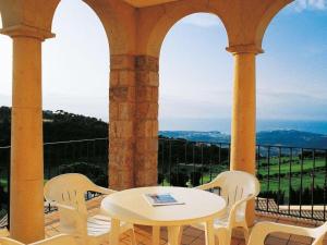 Castillo de AroにあるApartment Resort Hapimag Mas Nou by Interhomeの白いテーブルと椅子、景色を望むバルコニー