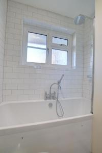 a bath tub with a shower in a bathroom at Holiday Home Wayfarer by Interhome in Woodbridge