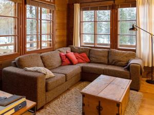 a living room with a couch and a table at Holiday Home Kivalonmaa a by Interhome in Äkäslompolo