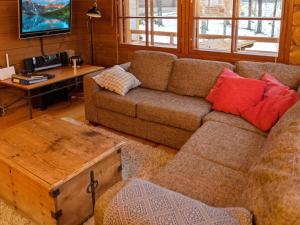 a living room with a couch and a coffee table at Holiday Home Kivalonmaa a by Interhome in Äkäslompolo