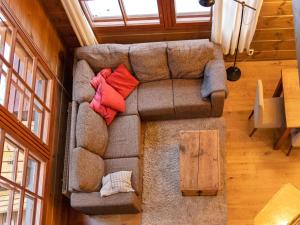 a couch in a living room with pillows on it at Holiday Home Kivalonmaa a by Interhome in Äkäslompolo