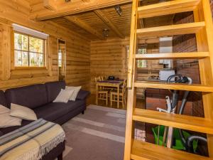 a living room with a couch and a table at Holiday Home Joutsen by Interhome in Vähäsalmi