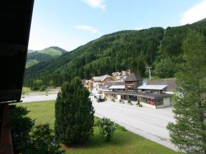 a town in the mountains with a parking lot at Apartment Almsommer by Interhome in Donnersbachwald