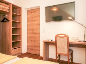 a bedroom with a desk with a chair and a mirror at Apartment Almsommer by Interhome in Donnersbachwald
