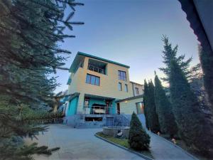 a large house with trees in front of it at Nat Craft - Вилла Гарден in Tsaghkadzor