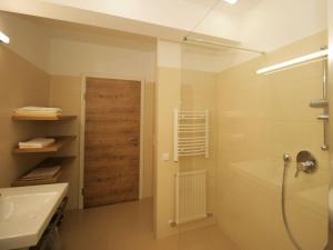 a bathroom with a tub and a sink and a shower at Apartment Almsommer by Interhome in Donnersbachwald