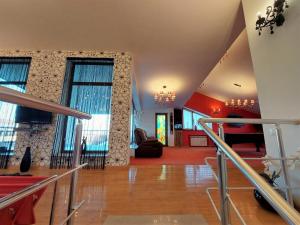 a room with a staircase and a living room at Nat Craft - Вилла Гарден in Tsaghkadzor