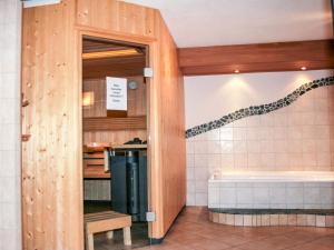 a bathroom with a bath tub and a sink at Apartment Almsommer by Interhome in Donnersbachwald