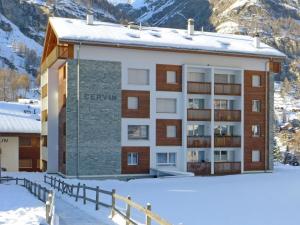 budynek w śniegu przed górą w obiekcie Apartment Cervin by Interhome w mieście Zermatt