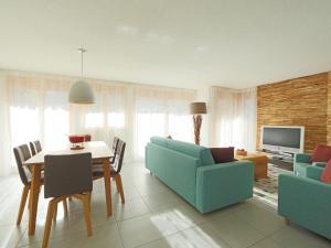 ein Wohnzimmer mit einem blauen Sofa und einem Tisch in der Unterkunft Apartment Susanna by Interhome in Zermatt