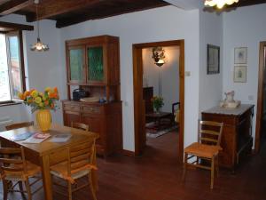 a kitchen and dining room with a table and chairs at Holiday Home Ai Funtann by Interhome in Casima
