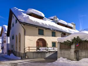 a house with snow on top of it at Apartment Chesa Olgiati by Interhome in Celerina