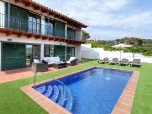 a swimming pool in the backyard of a house at Holiday Home Toscana by Interhome in Lloret de Mar