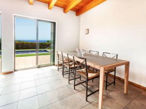 a dining room with a table and chairs and a view of the ocean at Holiday Home Toscana by Interhome in Lloret de Mar +20 photos