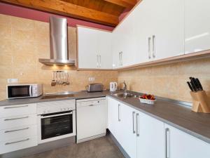 a kitchen with white cabinets and a sink at Holiday Home Toscana by Interhome in Lloret de Mar