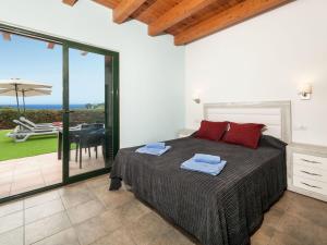 a bedroom with a bed and a view of the ocean at Holiday Home Toscana by Interhome in Lloret de Mar