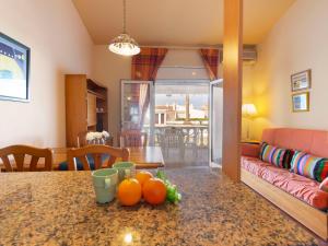 a kitchen and living room with a table with oranges on it at Holiday Home Salvagina 53 by Interhome in Riumar