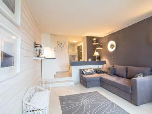 a living room with a couch and a table at Studio Les Marinas-10 by Interhome in Deauville