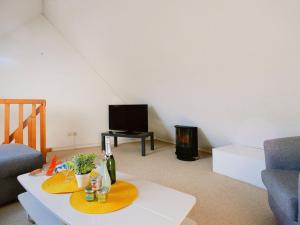 a living room with a table and a tv at Apartment Mer et Plages-3 by Interhome in Carnac-Plage